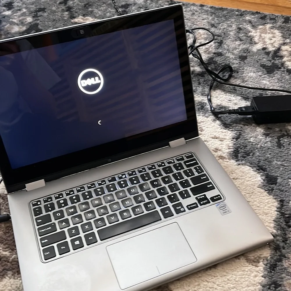 Silver Dell laptop that folds over to a tablet